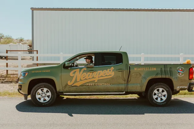 Side view of the NEARPEST pickup with gold lettering on the doors