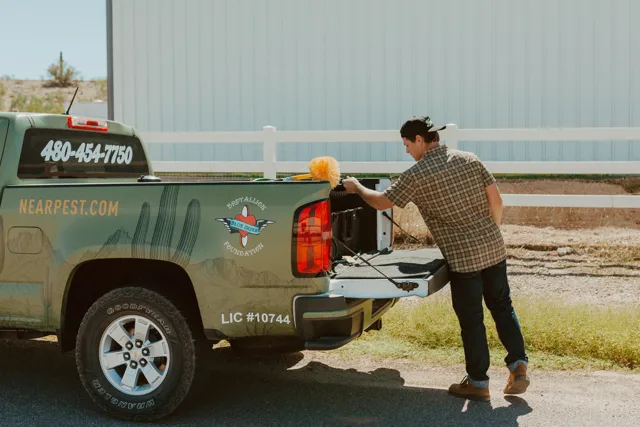 NEARPEST team member preparing equipment at the pickup tailgate