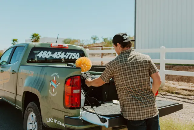 NEARPEST team member preparing equipment at the pickup tailgate