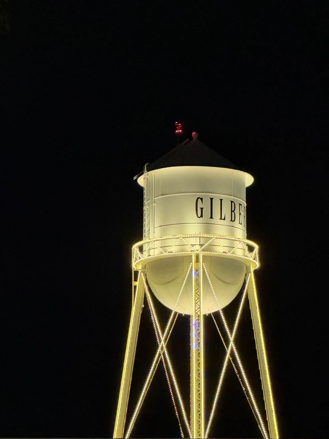 Gilbert water tower illuminated at night in downtown Gilbert, Arizona